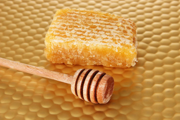 Honey comb and honey on bright yellow background