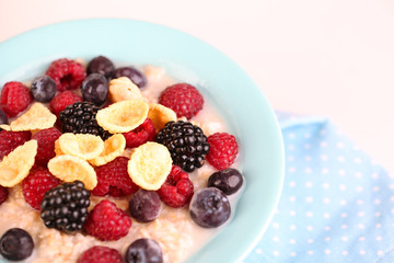 Oatmeal in bowl with berries isolated on white