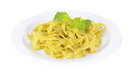 Delicious pasta with pesto on plate isolated on white