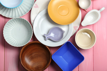 Different tableware on wooden background
