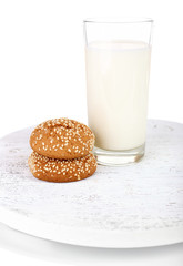 Milk and cookies on wooden tray isolated on white