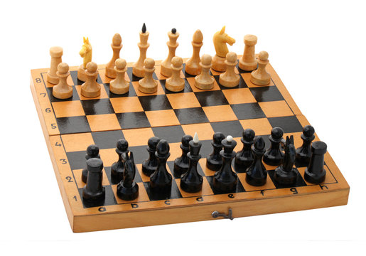 wooden chessboard with chessmen over white