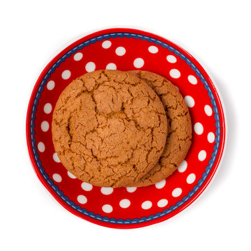 Ginger cookies on red white dotted dish isolated on white backgr