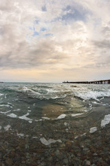 Sea landscape with pebble and pier