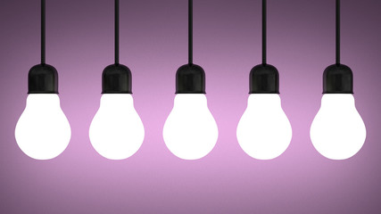 Hanging glowing tungsten light bulbs on violet