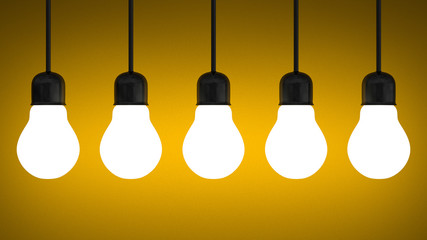 Hanging glowing tungsten light bulbs on yellow