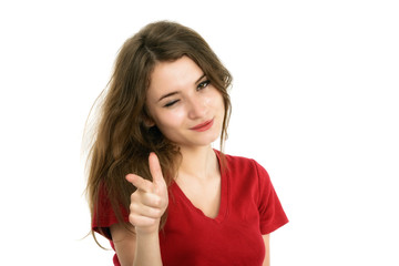Young smiling woman points a hand with positive facial expressio