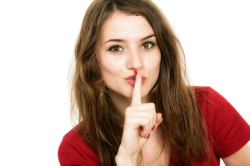 Portrait of beautiful woman with finger on lips, isolated over w