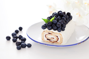 Cake roll with blueberry and cream cheese, selective focus