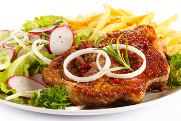 Grilled steak, French fries and vegetables