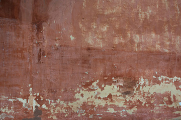 Rough textured background red old cement wall with stains, dry