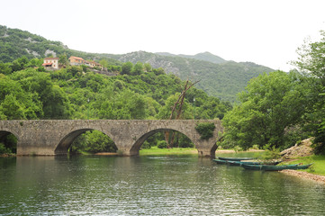 Fototapeta na wymiar The old arched stone bridge of Rijeka Crnojevica