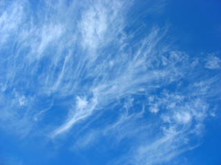 Blue sky background with fleecy clouds