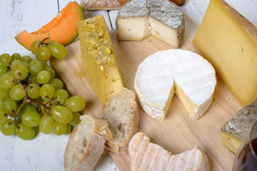 assortment of french cheeses and seasonal fruit