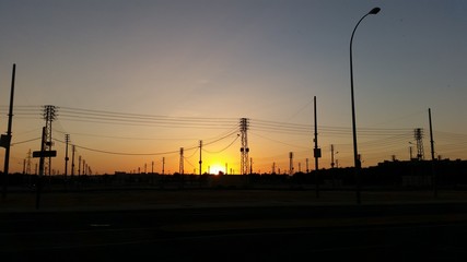 Industrial sunset silhouette with cranes and street lights © kukumi