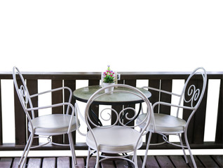 White table and chairs in garden.