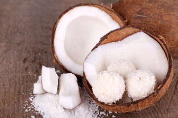 Broken coconut on wooden background