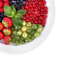 Forest berries on plate, isolated on white