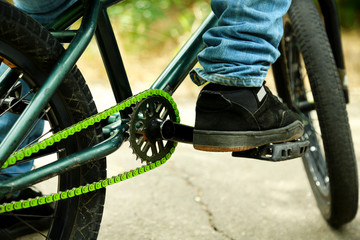Naklejka premium Young boy on BMX bike at park