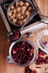 Dried hibiscus tea in glass jar, brown sugar  in box