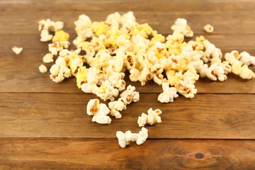 Popcorn on wooden table, close up
