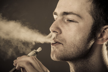 Man smokes electronic cigarette