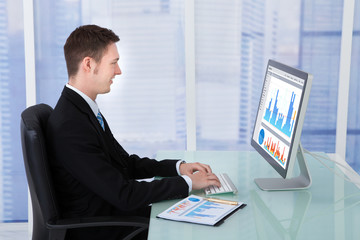 Concentrated Businessman Working On Computer In Office