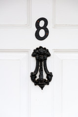Door number 8 and door knocker close up for use as a background