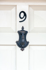 Number 9 and door knocker close up
