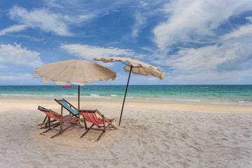 Beach chairs with umbrella and beautiful beach