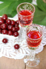 Fototapeta na wymiar Cherry liqueur and fresh cherry