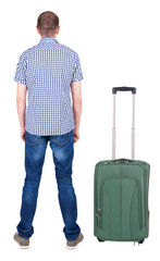 Back view of young man traveling with suitcas.