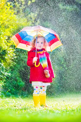 Little sweet girl playing in the rain