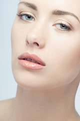 Fototapeta premium Closeup portrait of young beautiful green eyed woman