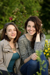 Two beautiful young women smiling on a summer day