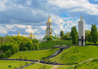 Fototapeta na wymiar Monument to victims of Holodomor and Kiev-Pechersk Lavra in Kiev