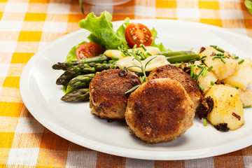 Meatballs served with boiled potatoes and asparagus