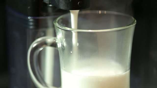 coffee a machine prepares lat with milk