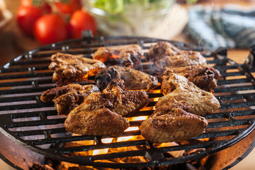 Grilling chicken wings on barbecue grill
