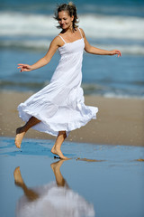 young happy woman on the beach in summer