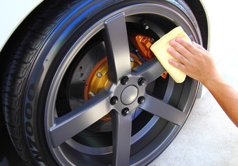 Hand with a microfiber wipe the car polishing