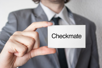 Checkmate. Businessman showing business card