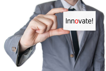 Innovate. Businessman holding business card