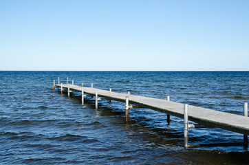 Wooden bath pier in blue water