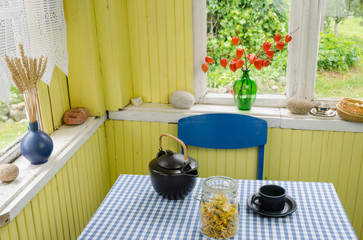 rural room and ceramic tea set calendula on table