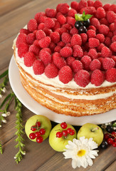 Tasty cake with fresh berries on wooden table