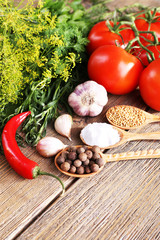 Fresh vegetables with herbs and spices on table, close-up