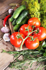 Fresh vegetables with herbs and spices on table, close-up