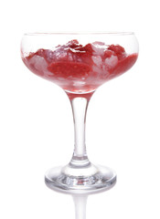Glass of cold raspberry dessert on wooden background