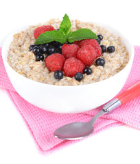 Tasty oatmeal with berries isolated on white